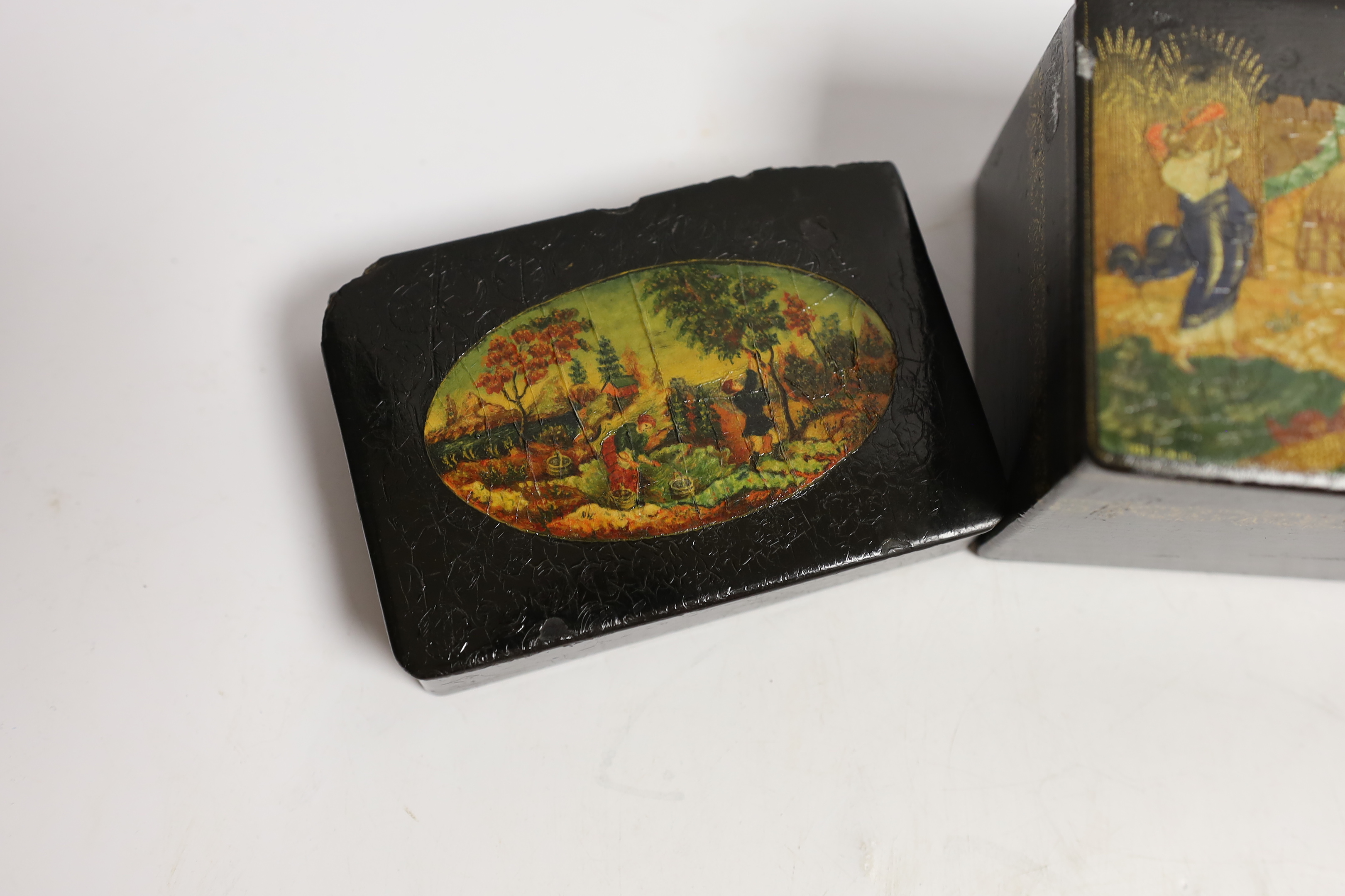 Four Russian lacquer boxes and a similar napkin ring, Palekh and others, the oval box painted with figures from legend and the others with rural scenes, some inscribed with the subject or artist, largest 13.7cm wide (5)